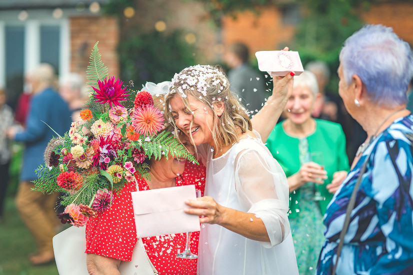 Bride hugging with bouquet of flowers